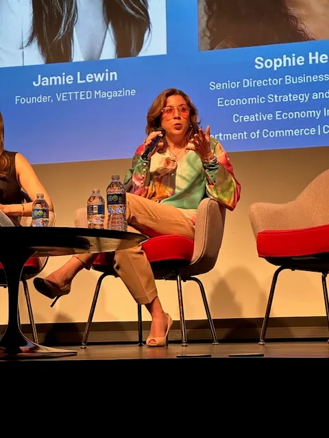 Antonella Colella speaking on a panel at an industry conference